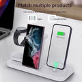 White three-in-one wireless charging station for mobile phone, headphones and smartwatch on a desk.