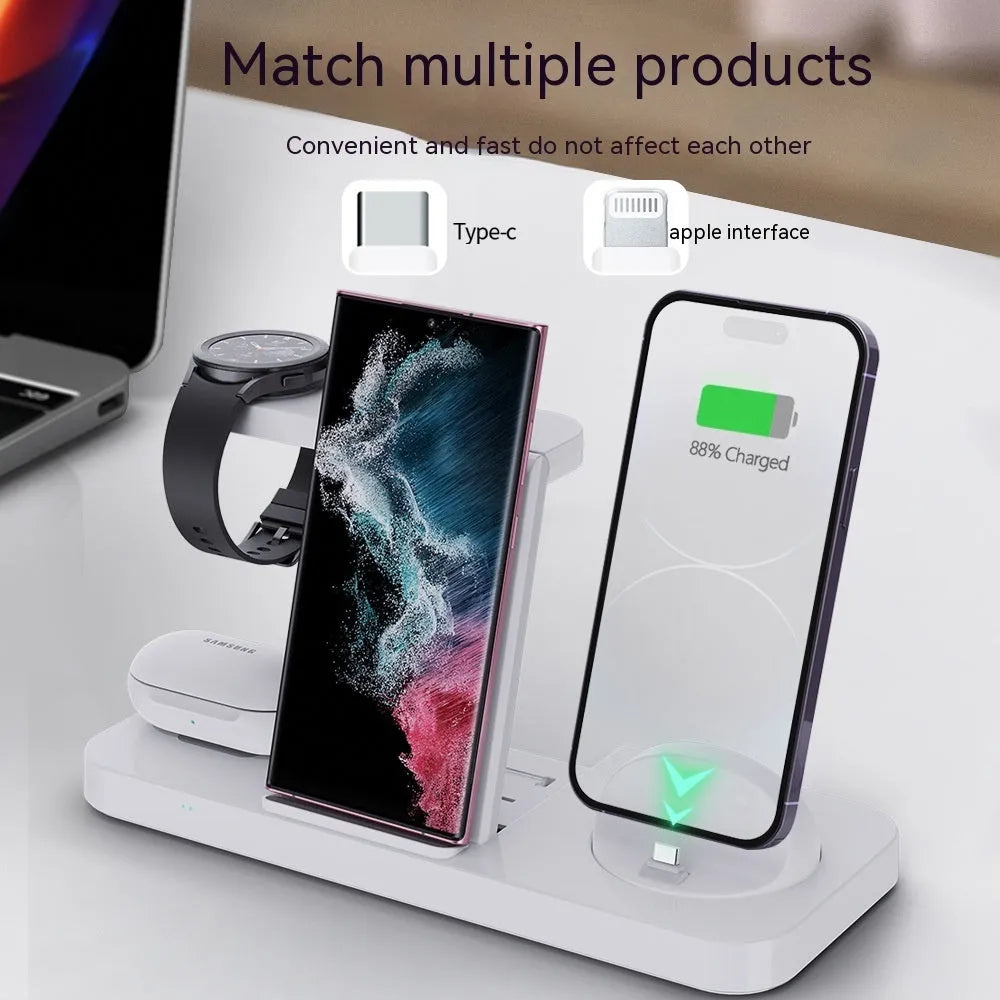 White three-in-one wireless charging station for mobile phone, headphones and smartwatch on a desk.
