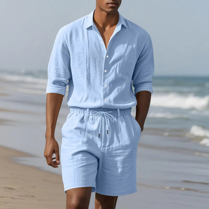 Men's white linen long-sleeve shirt and matching shorts beach suit set laid flat.