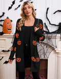 Women's black cardigan with orange pumpkin head jacquard knit pattern, shown as a medium-length coat.