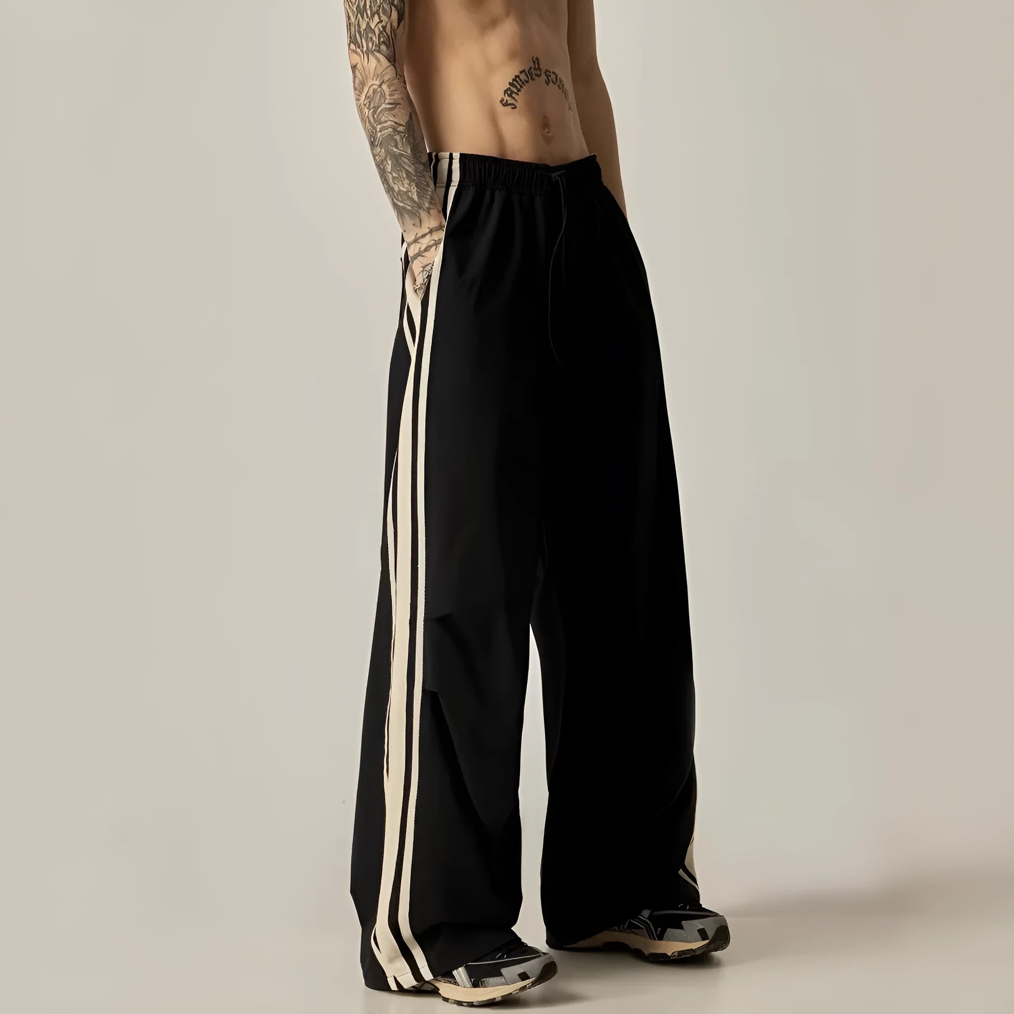 Black high-waist wide-leg climbing trousers for men laid flat, showing straight-leg style.