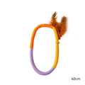Circular green cotton rope cat toy with feathers and catnip.