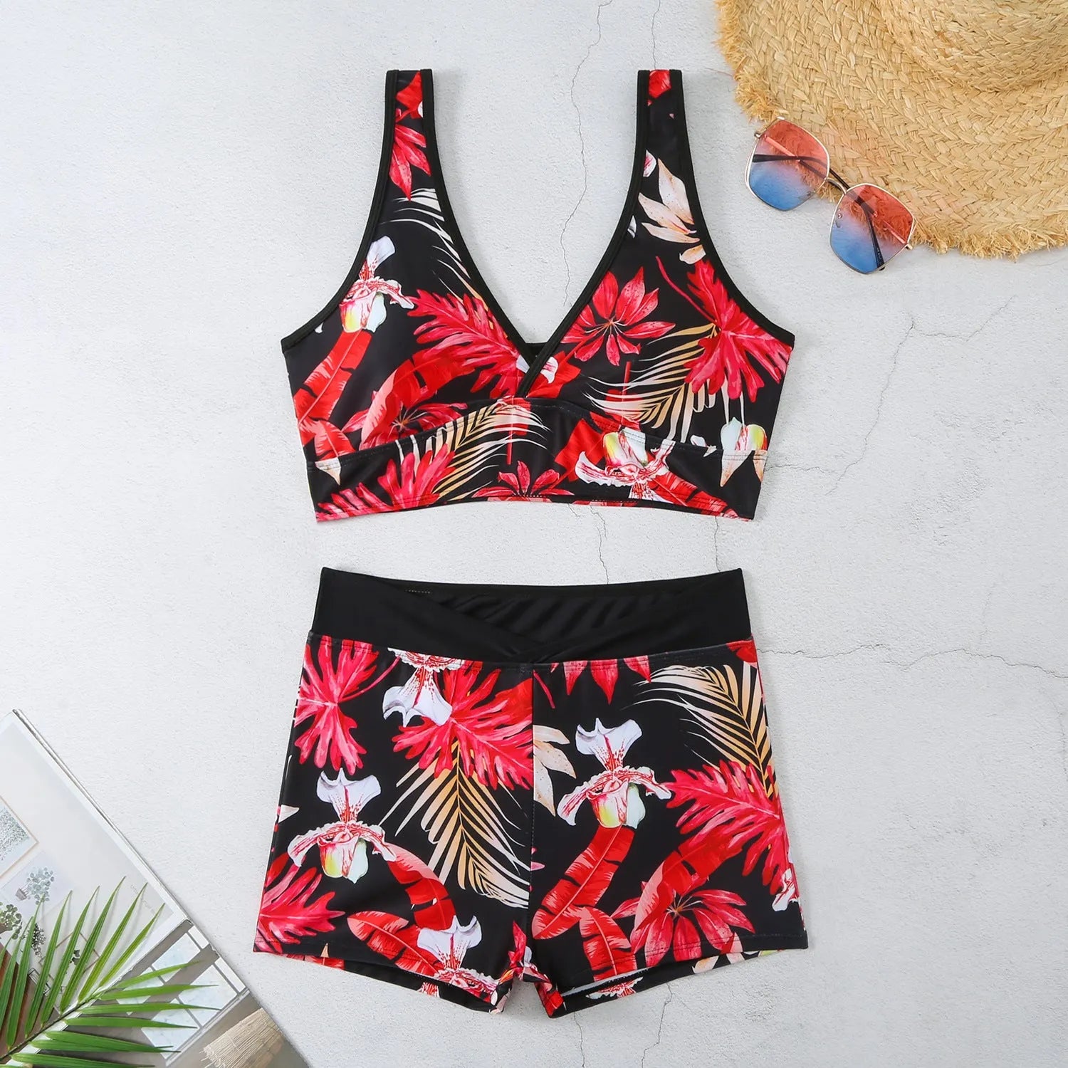 Women's two-piece swimsuit with sleeveless top and printed boxer brief bottoms in a multi-colour pattern.