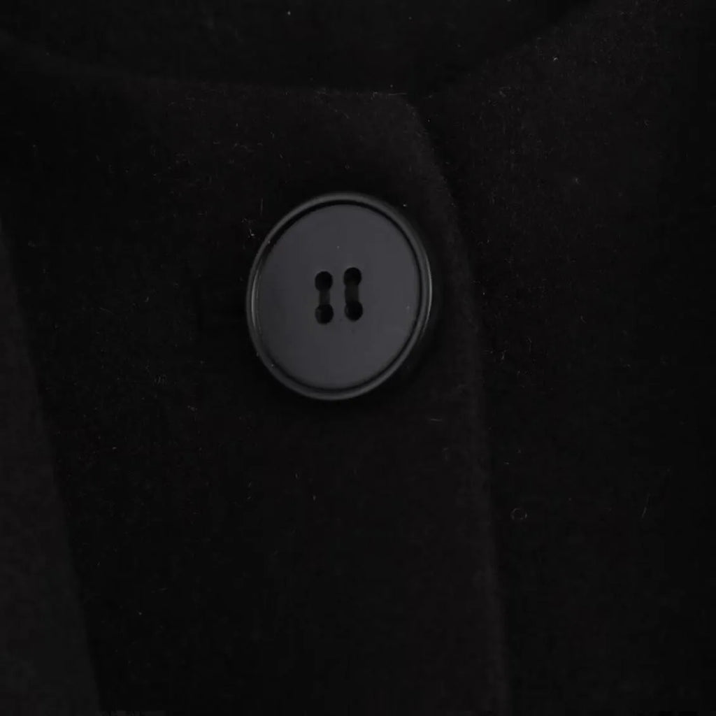 Women's long black polyester overcoat with a fluffy artificial fur collar, shown on a hanger.