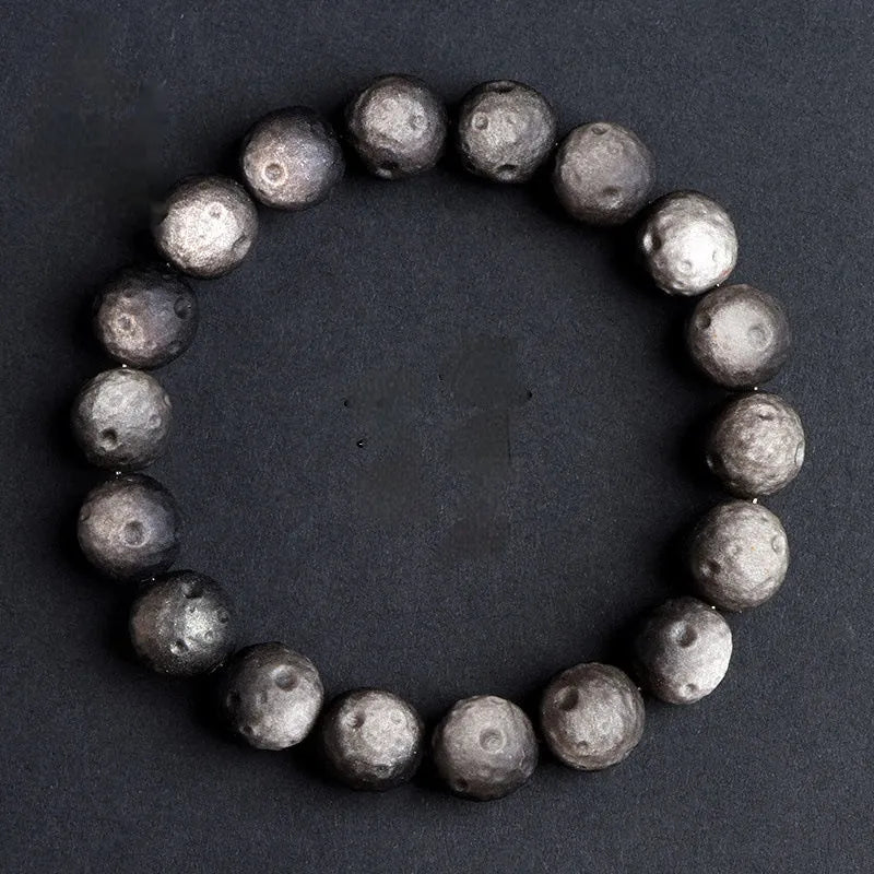 Unisex natural obsidian crater ball bracelet in silver stone meteorite colour with textured beads.