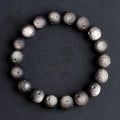 Unisex natural obsidian crater ball bracelet in silver stone meteorite colour with textured beads.