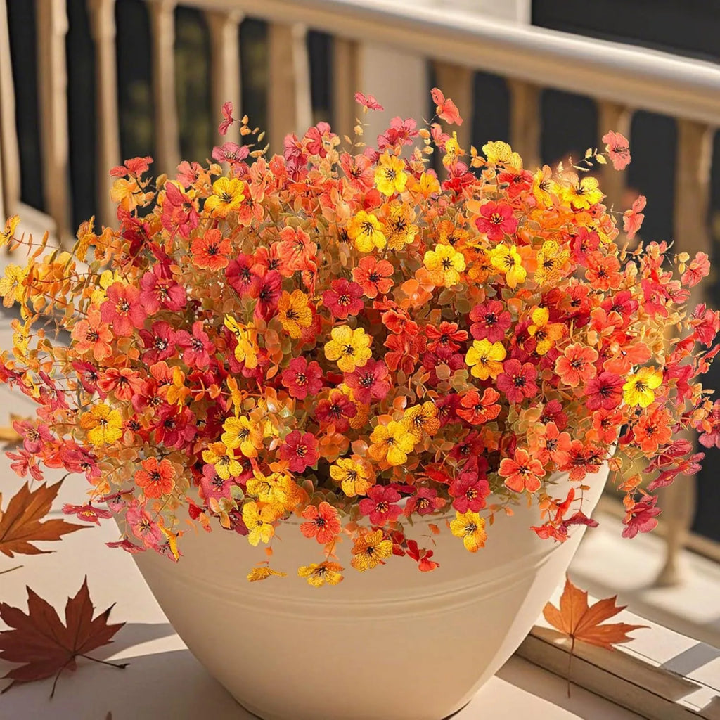 Artificial flower bouquet in autumn colours made from plastic and silk materials.