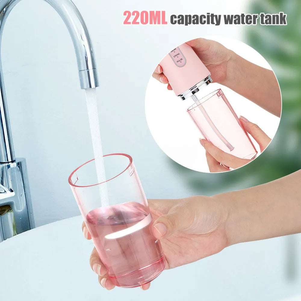 Handheld electric water pick in white, pink or light green with three speed settings, under 300mL tank, USB cable and four nozzles