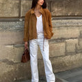Retro solid colour loose fit polyester jacket on a hanger, showing long sleeves.