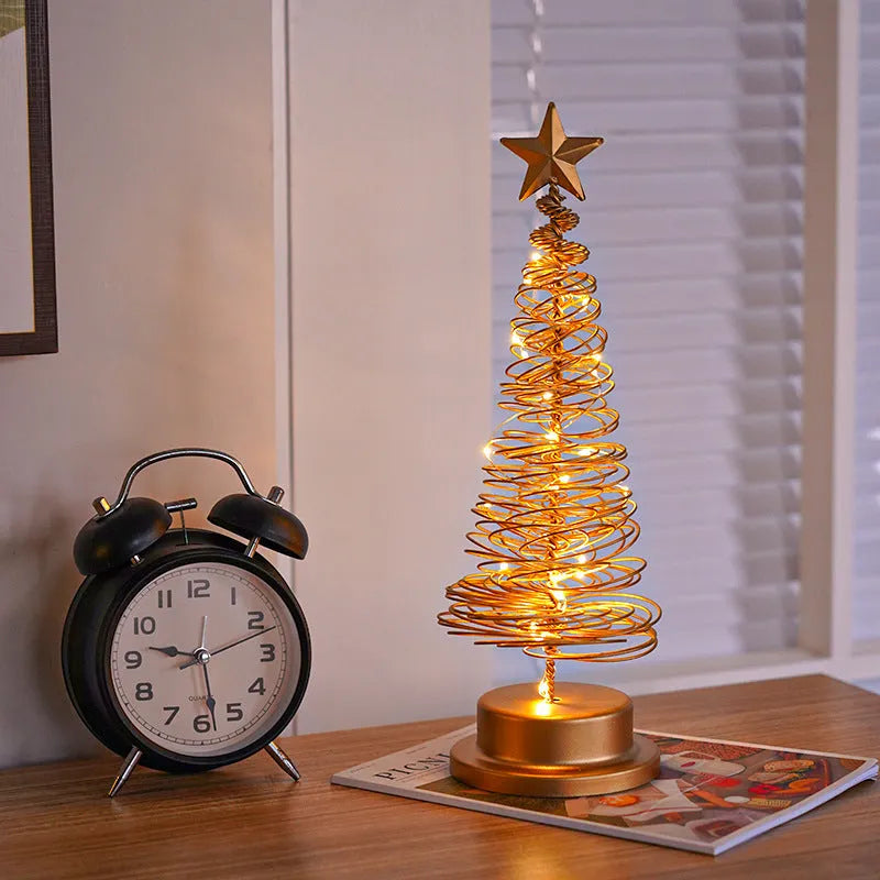 Wrought iron LED Christmas tree spiral light on a table, glowing warm white.
