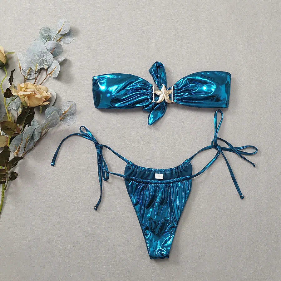 Women's glossy sapphire blue bikini set with gold starfish decoration, showing tube top and briefs.