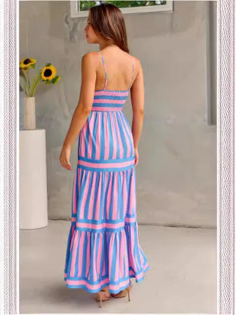 Woman wearing a striped, backless long summer dress with square neckline, suspender straps, and side pockets.