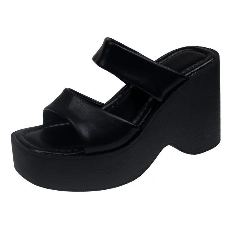 Women's black wedge platform slippers with square toe on a white background.