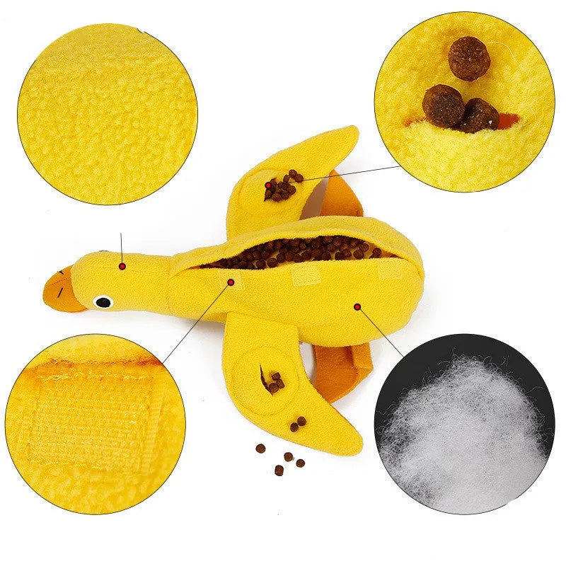 Yellow plush duck dog training toy with a squeaker and treat compartments on a white background.