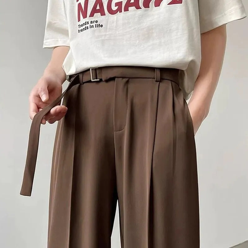 Model wearing thin black straight wide leg casual trousers with a loose fit.