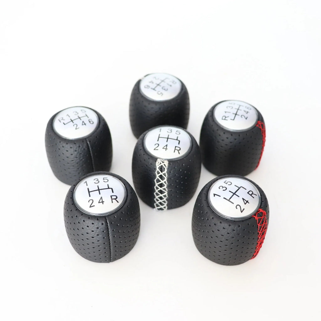 Perforated leather gear shift handball for Alpha car in black, red, and white line colour options.