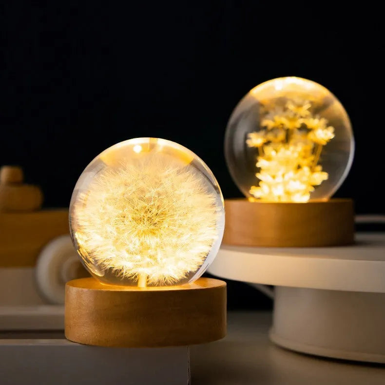 USB-powered eternal flower night light with clear resin crystal ball on a natural beech wood base.