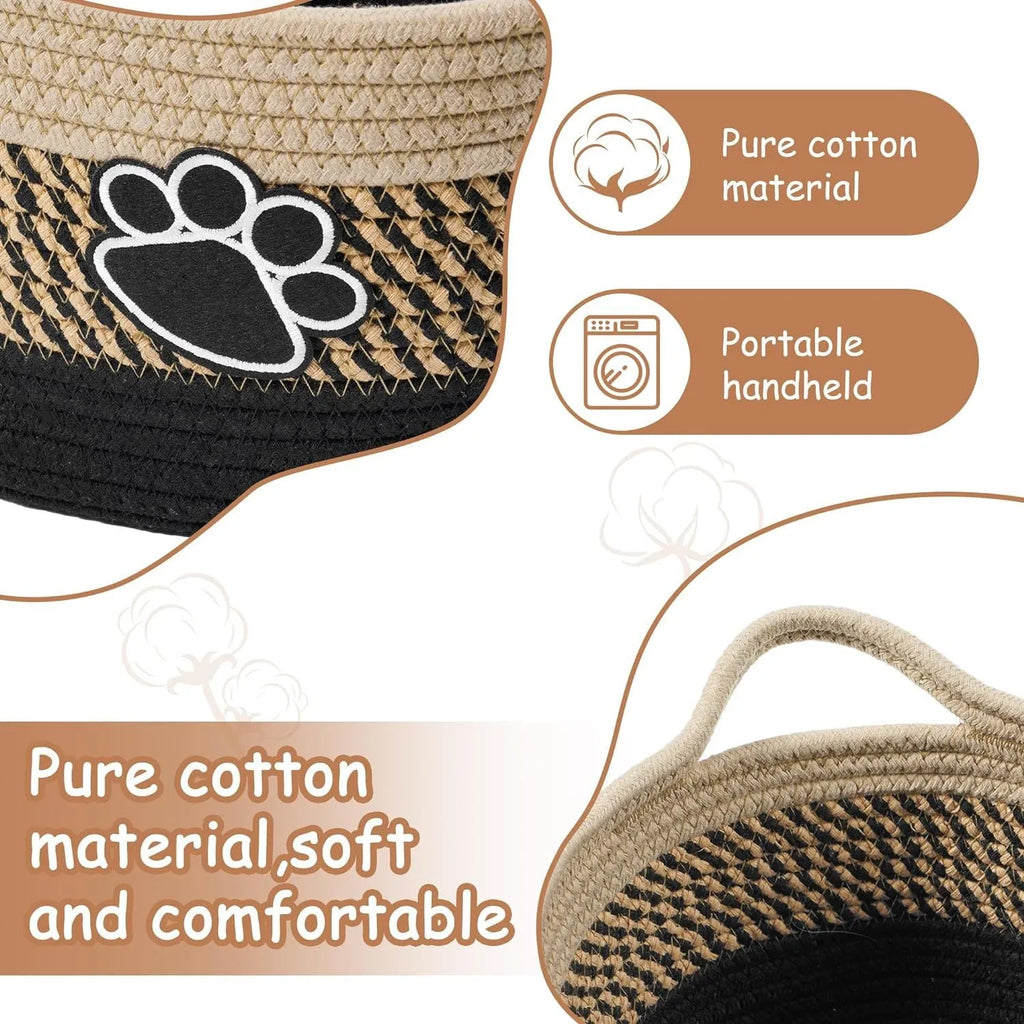 Light beige handmade cotton rope woven storage basket with handle on a wooden base.