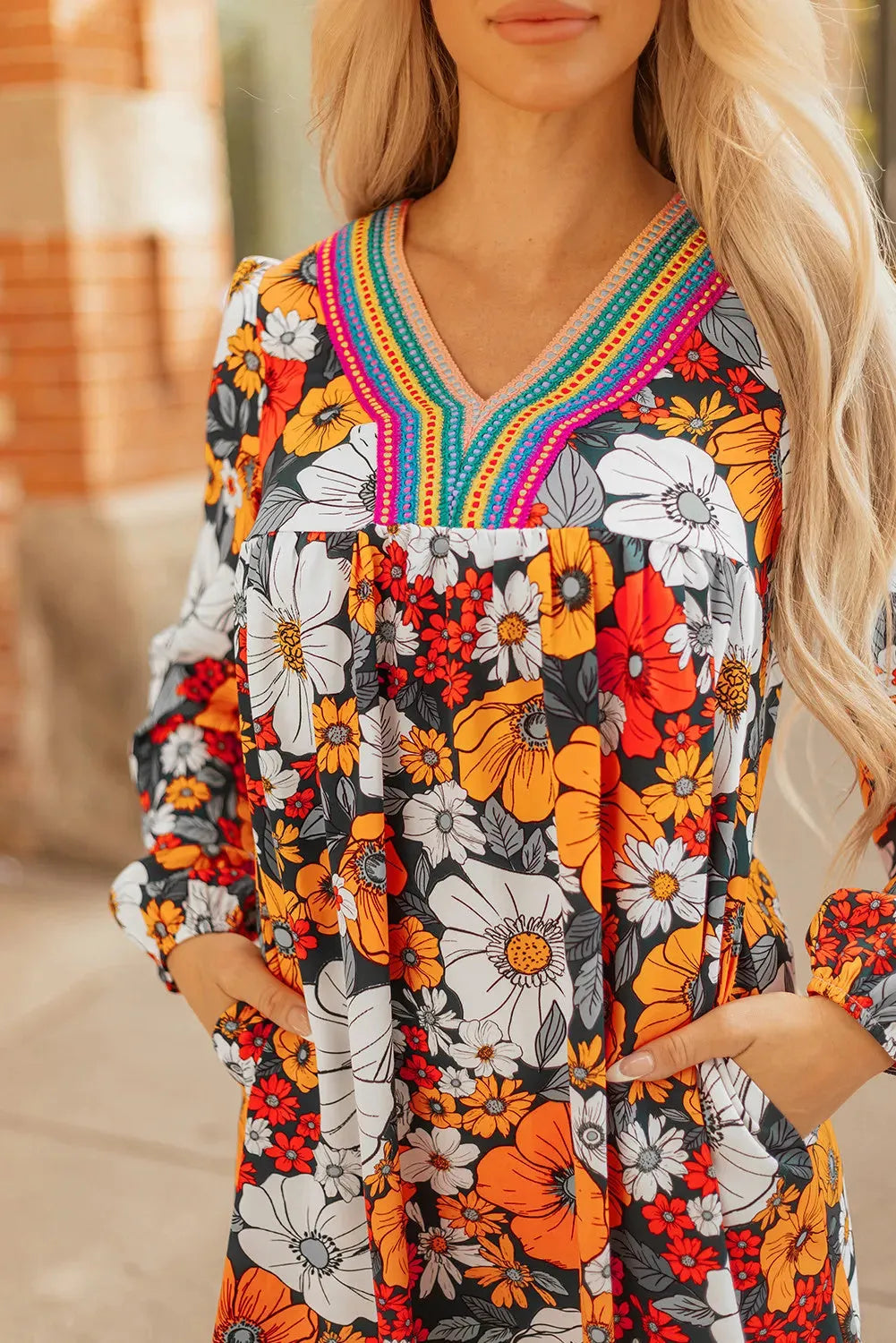 Orange striped floral print mini dress with long sleeves, V-neck, and lace detailing.