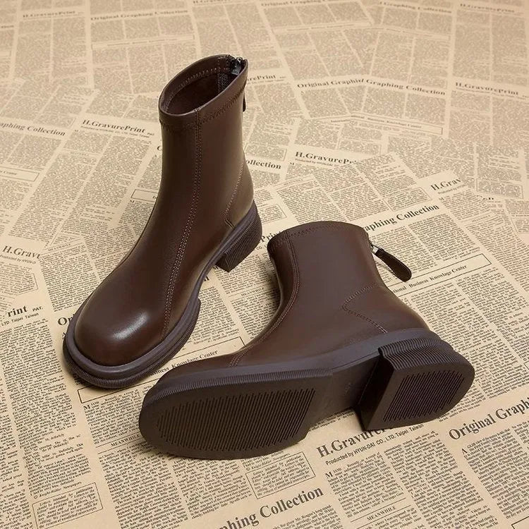 Women's black flat heel ankle boots with a back zipper and round toe