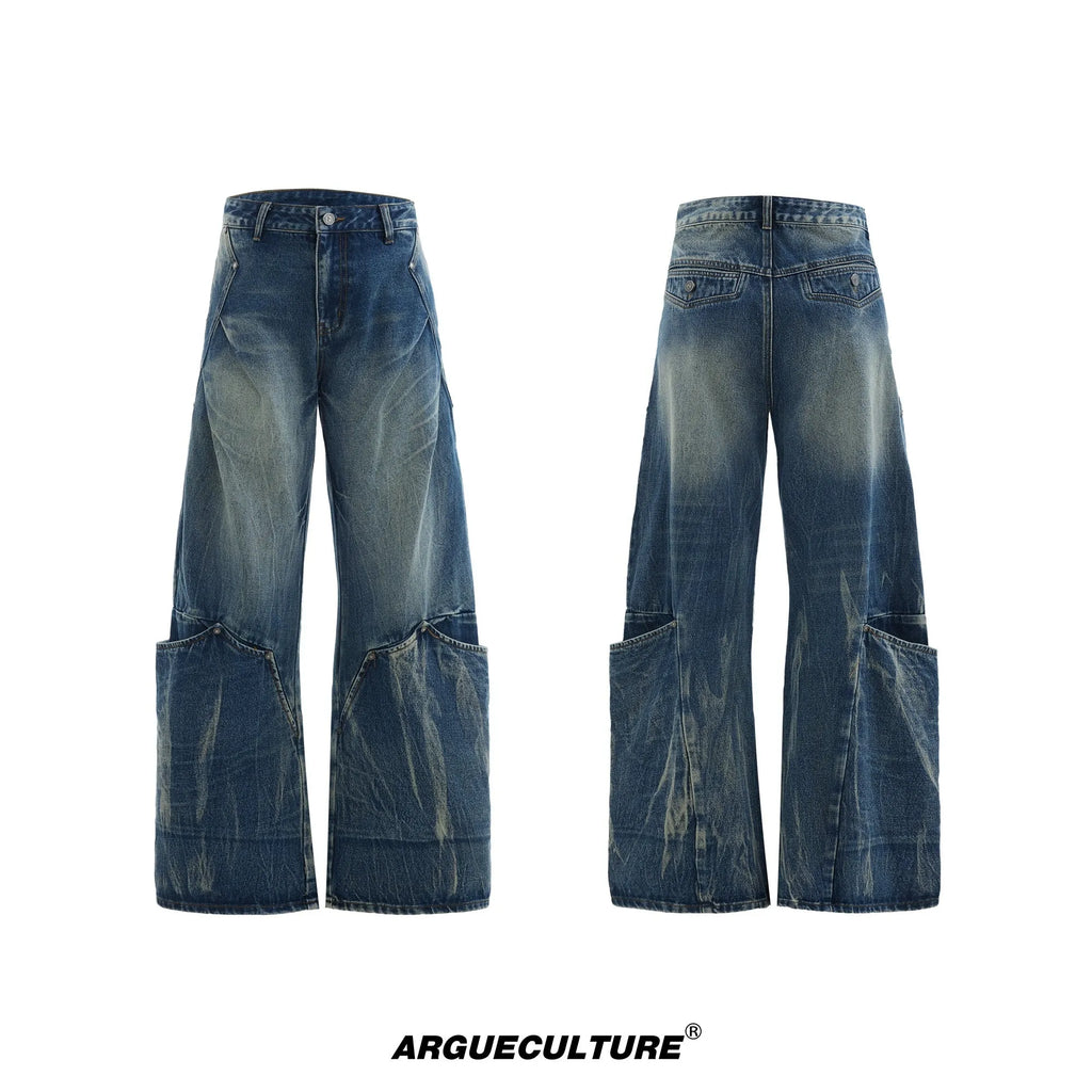 Man wearing Verdant Blue loose fit jeans with a retro washed burst pattern and a curved knife leg silhouette.