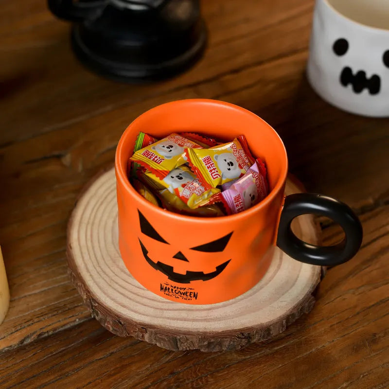 Orange ceramic pumpkin mug with handle on gift box with dessert spoon