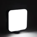 Compact black LED mini square camera flash with rotatable head on a small tripod stand