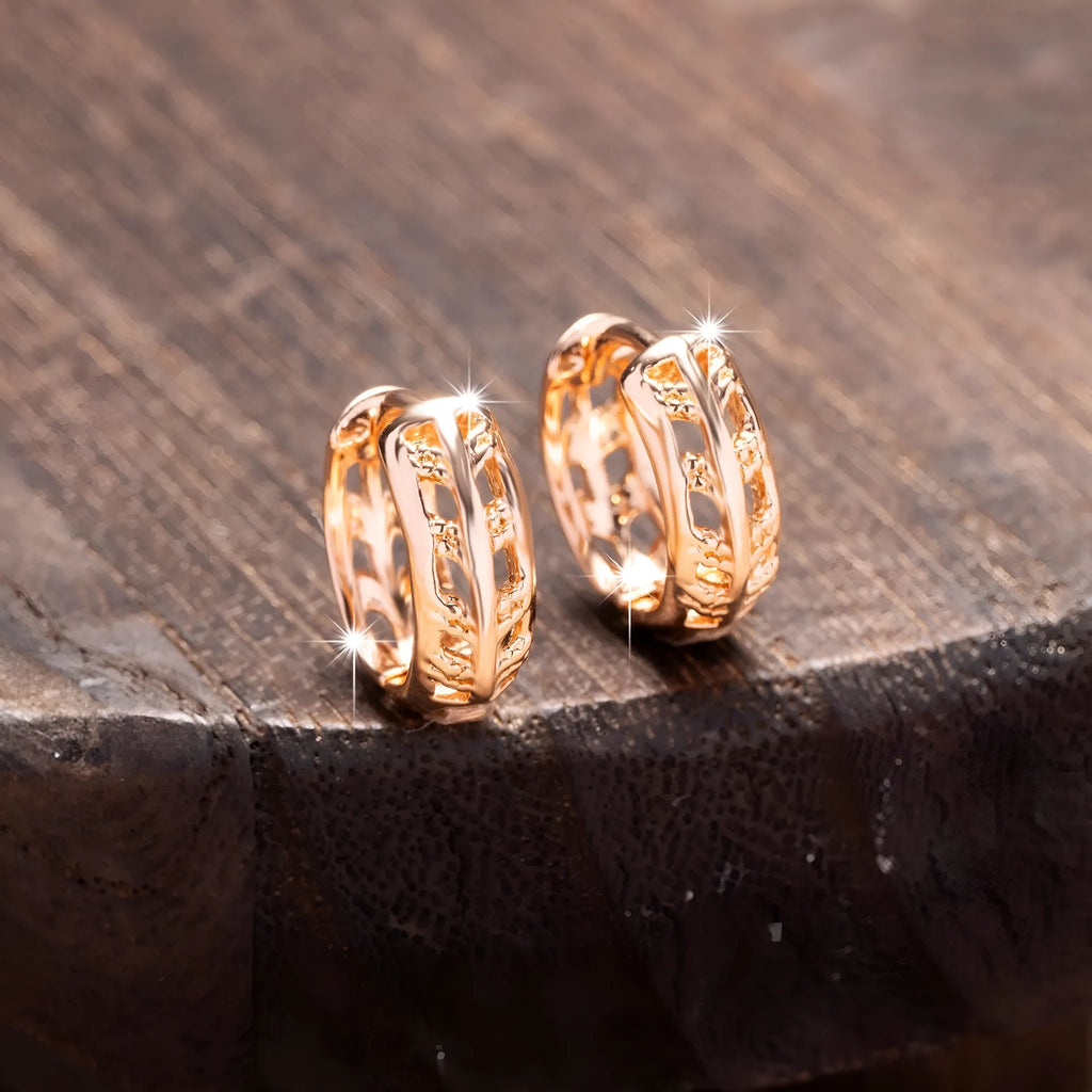 Rose gold plated copper earrings with hollow heart and leaf shapes, shown from front, approx 2.5cm tall.