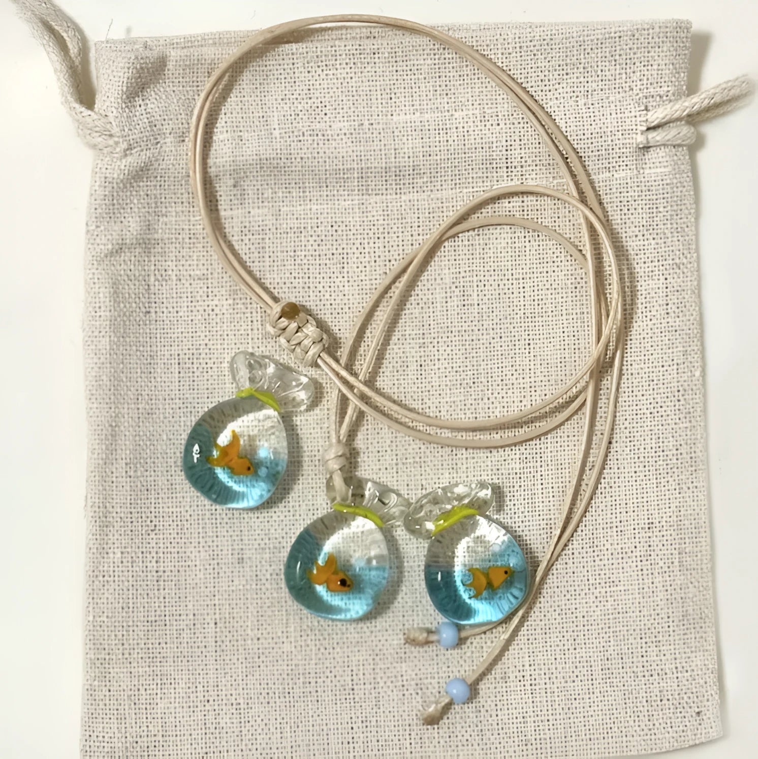 Women's joker pendant necklace on braided cotton linen cord with adjustable lobster clasp.