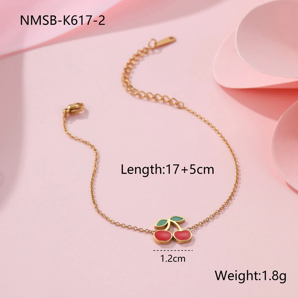 Cherry jewellery set showing necklace, bracelet, earrings, and ring with stainless steel construction