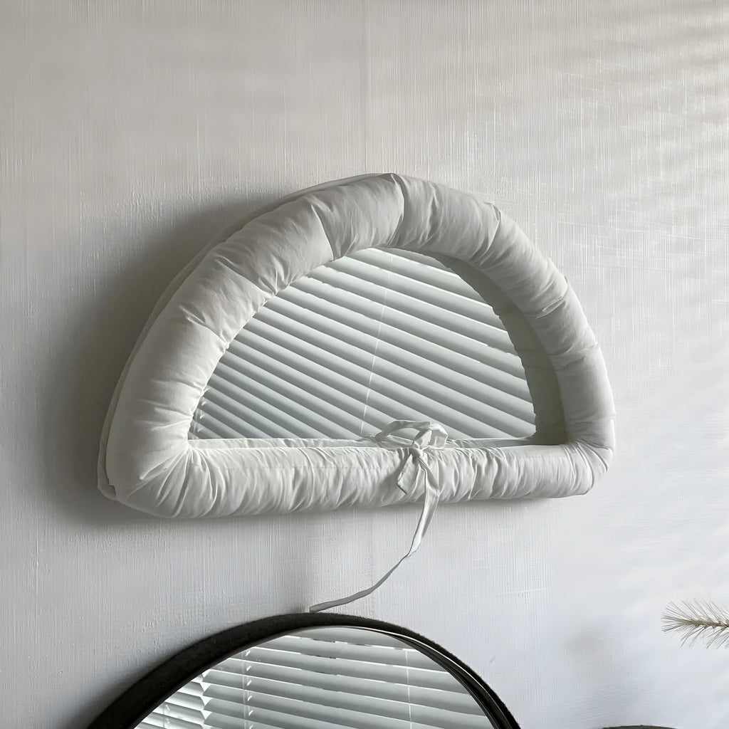 Hanging wall mirror with soft cotton-filled fabric border in black, sapphire blue, or white