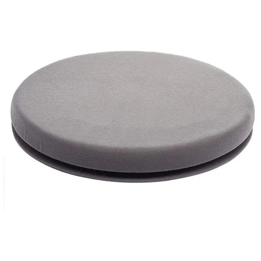 A grey rotating car seat cushion for lumbar support on a car seat.