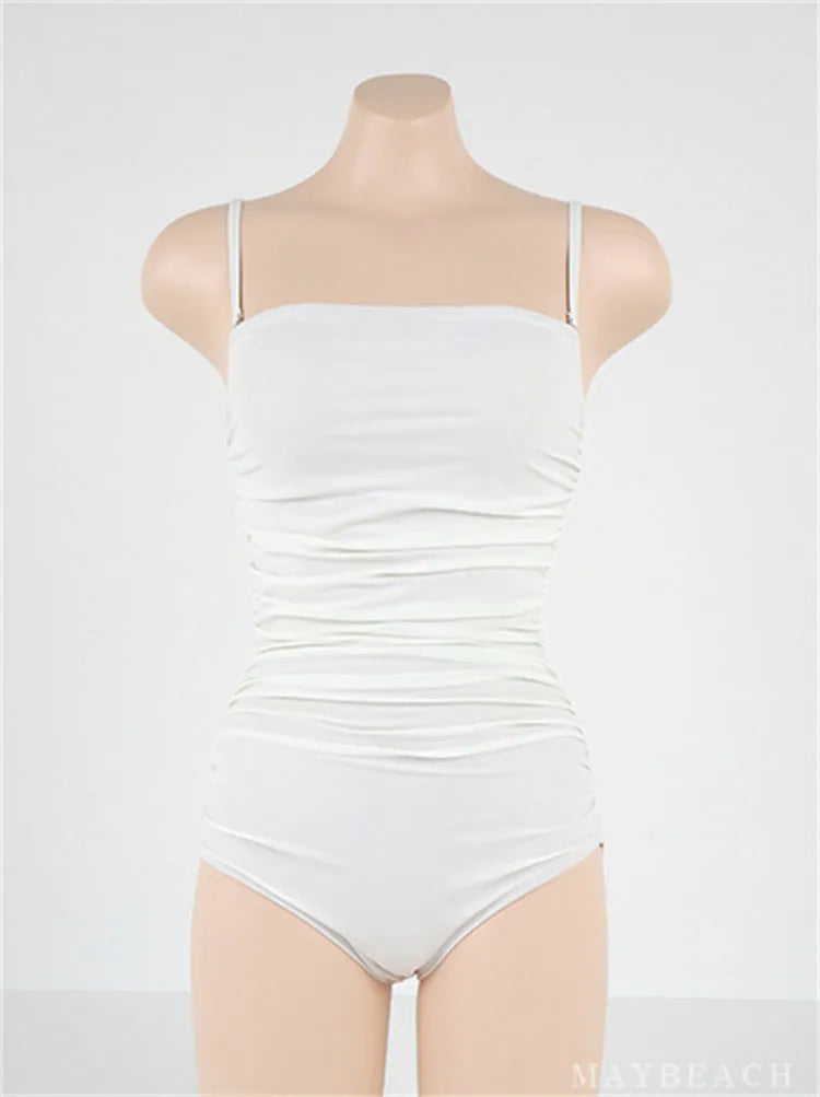 Blue sling style one-piece swimsuit with belly pleating on a mannequin.