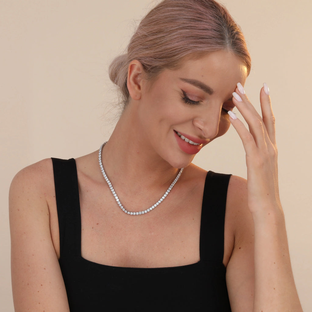 925 sterling silver tennis chain necklace with 4mm cubic zirconia stones and white gold plating on white background