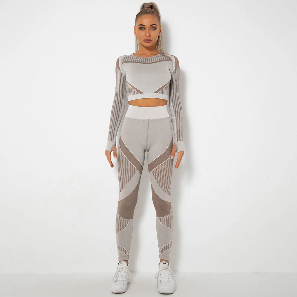 Women's long-sleeved seamless yoga wearsuit in a dark colour, shown in a yoga pose.