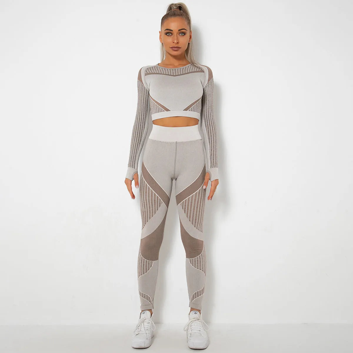 Women's long-sleeved seamless yoga wearsuit in a dark colour, shown in a yoga pose.