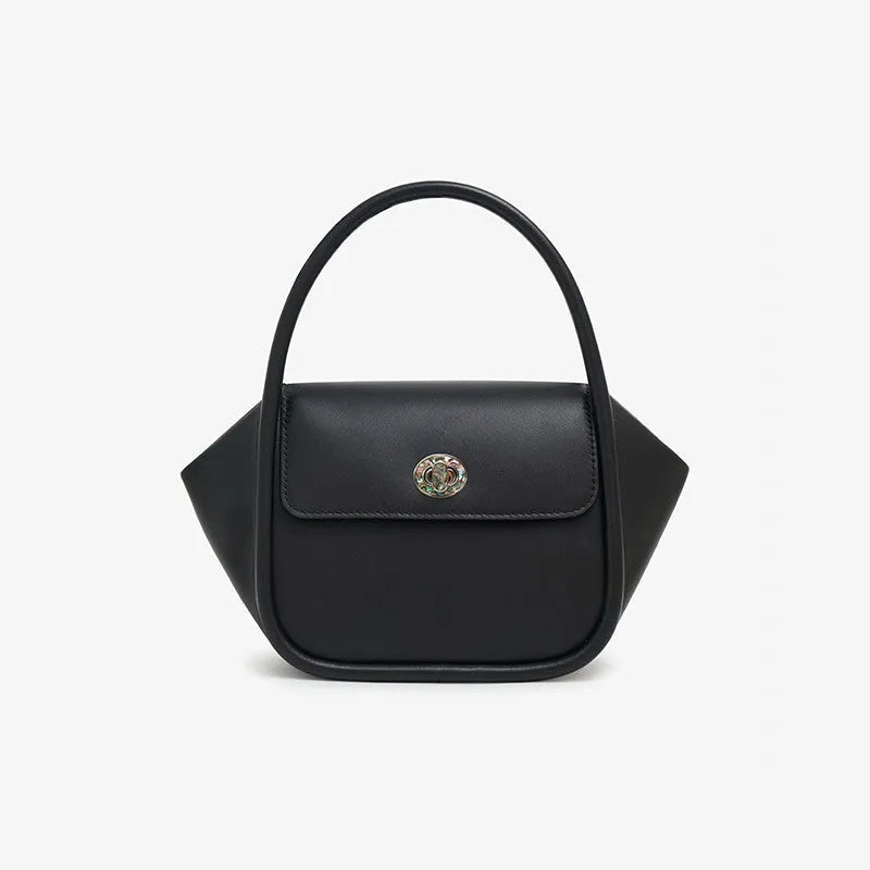 Brown leather wing-shaped tote bag with a buckle detail and latch closure, shown with a single cross-body strap.