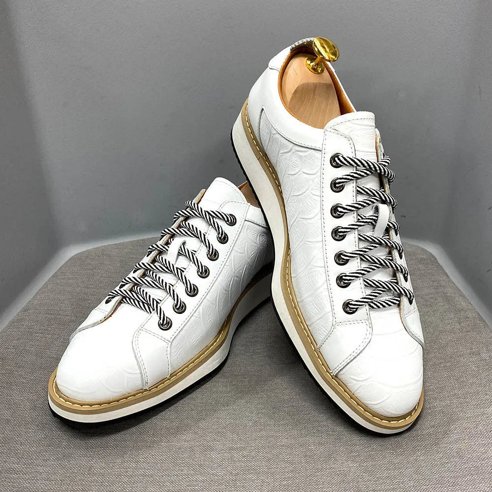 Men's low-top handmade shoes with embossed pattern on upper, shown in black with front tie laces.
