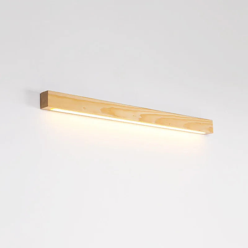 Modern walnut-coloured wood and acrylic log strip wall lamp in three lengths on a white wall.
