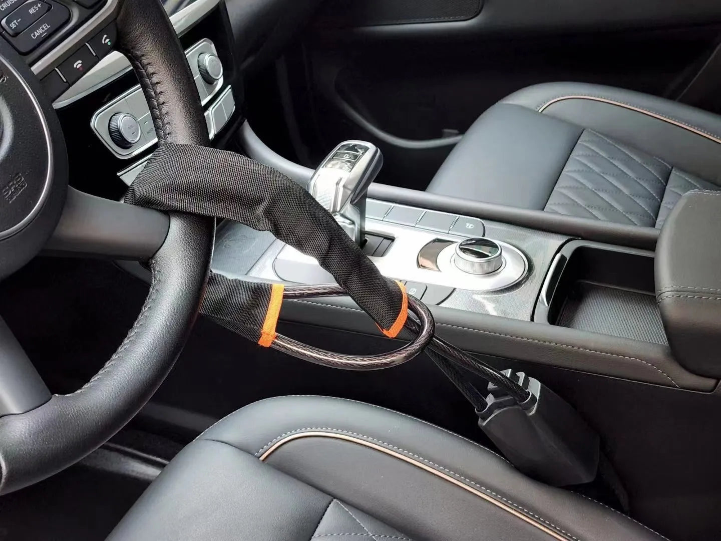 Red iron car steering wheel lock for General Motors vehicles on a steering wheel.