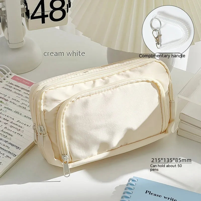 Double layer pencil case in solid colour with gift handle showing interior compartments