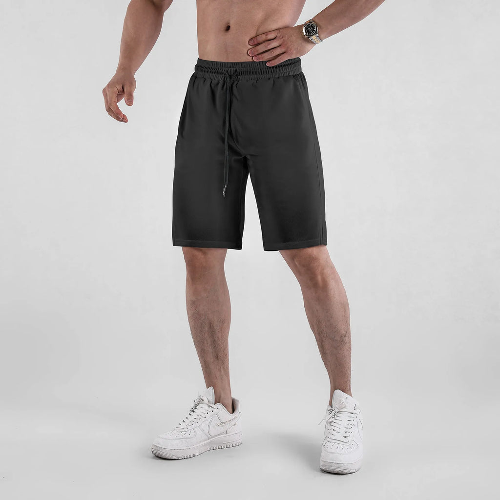 Men's black quick-drying mesh shorts with a loose fit and elastic waistband for summer sports.