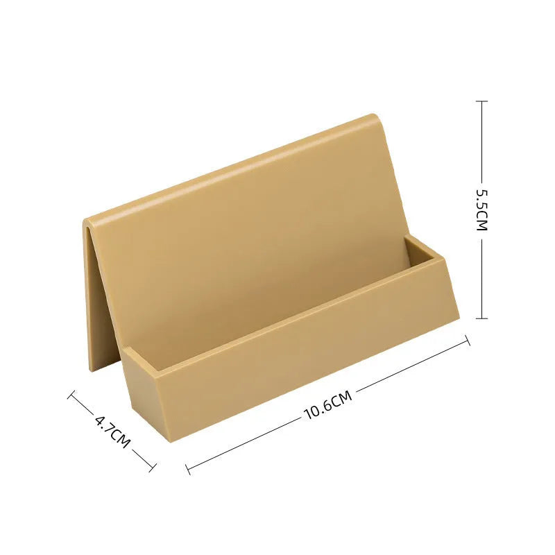 Creative PS geometric business card stand in brown, holding 20 cards upright on a desk.