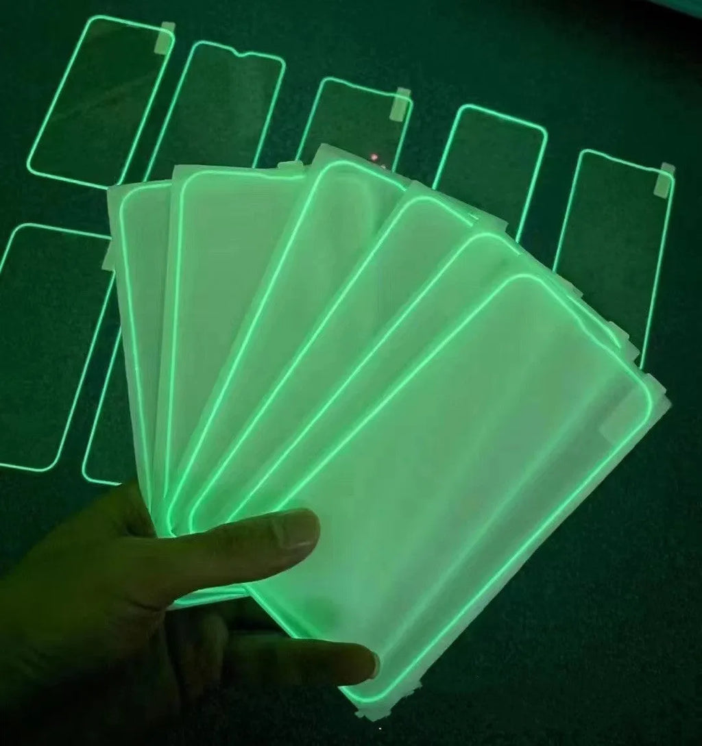 Fluorescent pink tempered glass screen protector applied to an iPhone 13 Pro, glowing softly on a dark background.