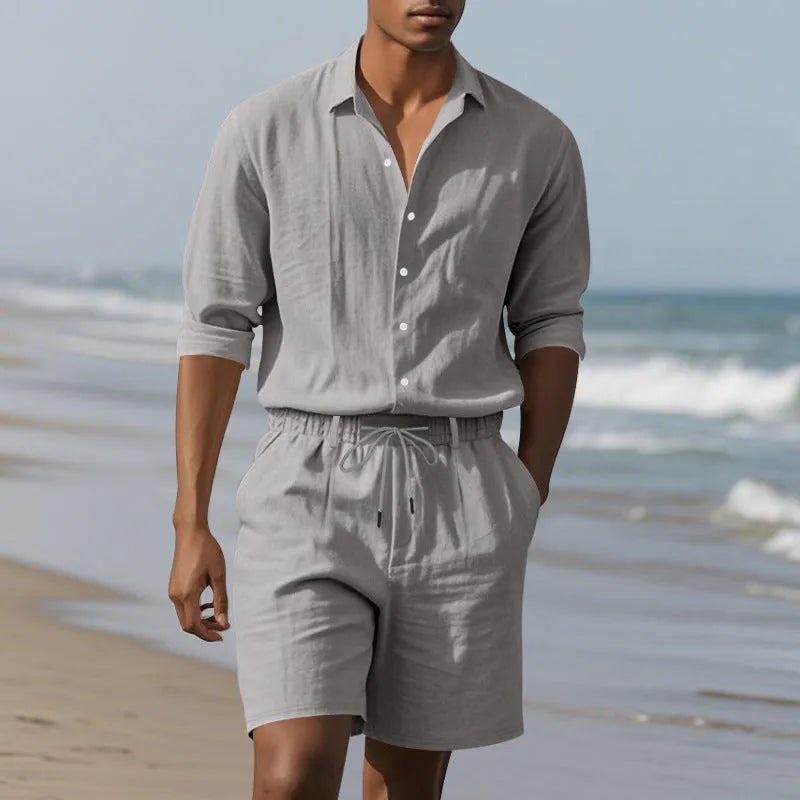 Men's white linen long-sleeve shirt and matching shorts beach suit set laid flat.