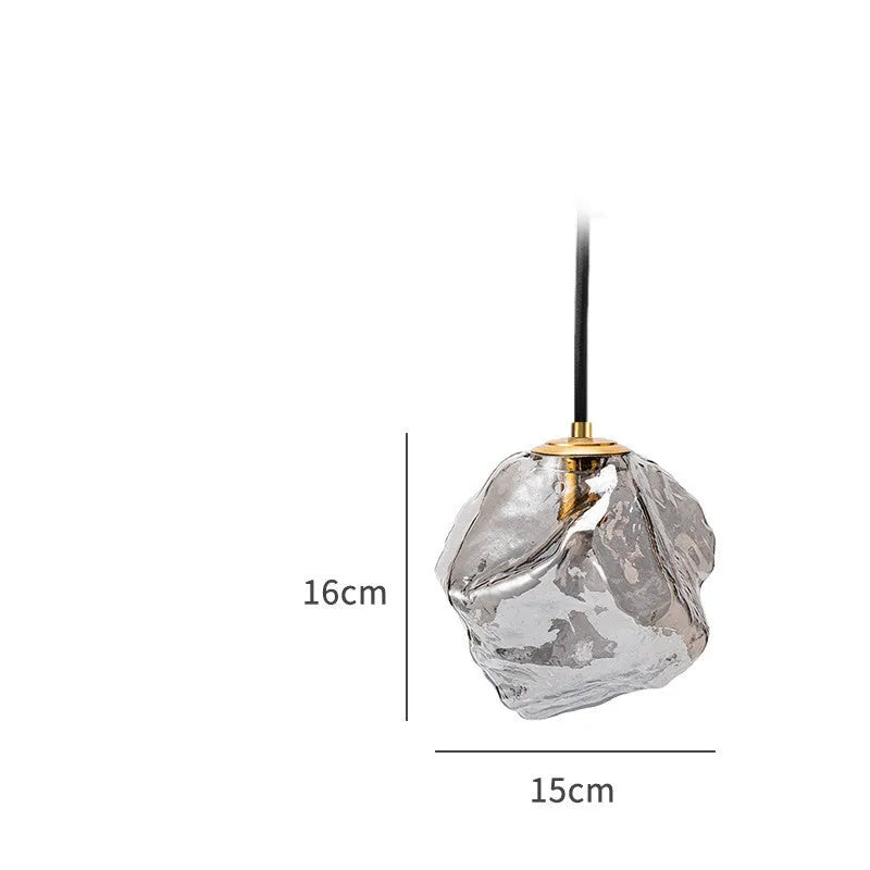 Minimalist ice cube glass chandelier with warm 4000K light, smoky grey shade and black hanging wire over a dining table