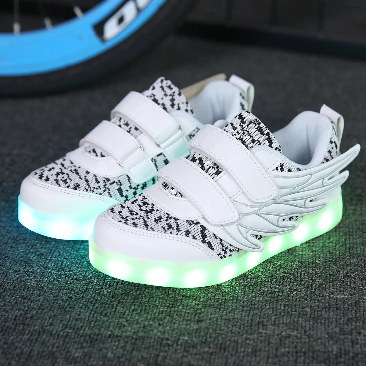 Children's plum red and white LED light-up sneakers with USB charging port on the side.