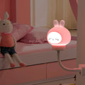 USB portable LED night light with remote control in cartoon bear design on bedside table