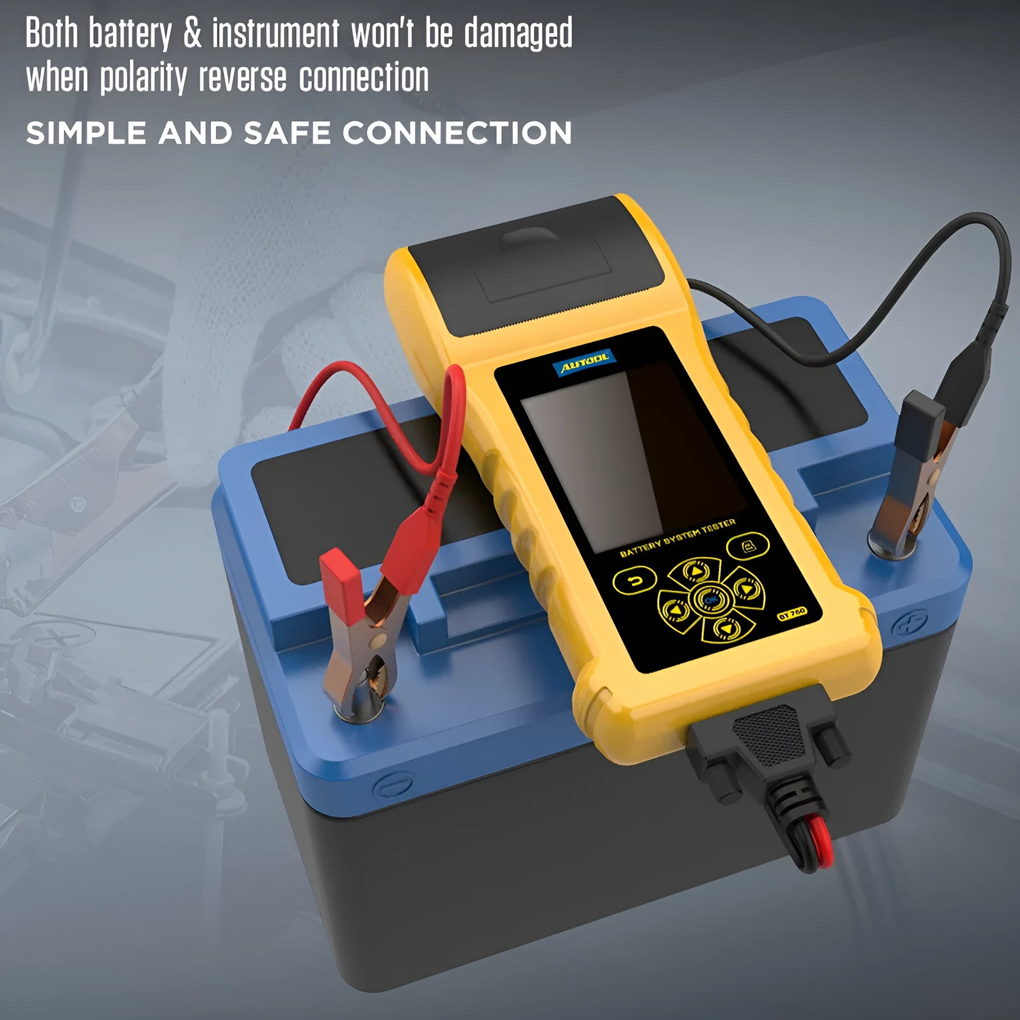 Autool BT760 vehicle battery tester with colour screen and attached test clips on a workbench.