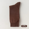 Five pairs of men's solid colour mid-calf socks made from combed cotton, shown in assorted colours.